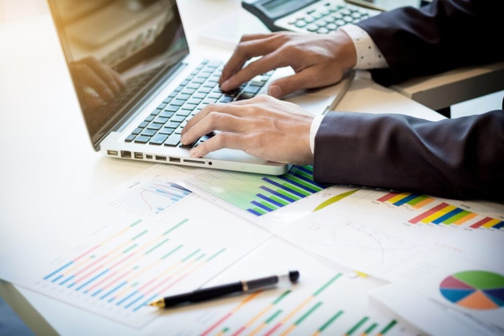 working process startup businessman working wood table with new finance project modern notebook table pen holding hand scaled.jpg